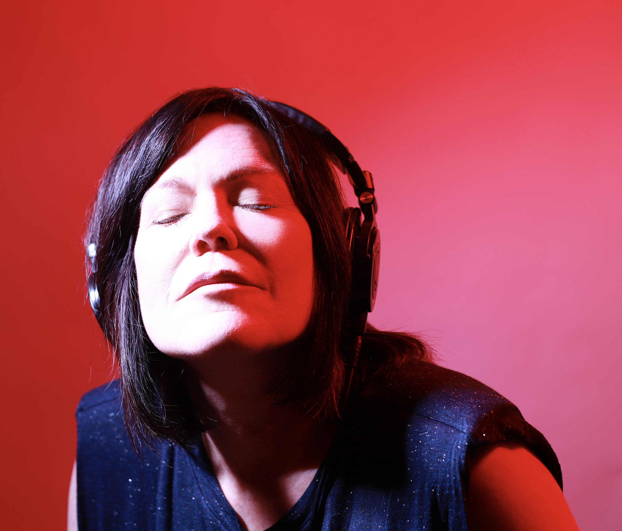 Shell Robinson wearing headphones with red lighting